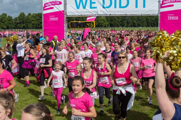 Thousands of runners cross the start line at Worcester Racecourse