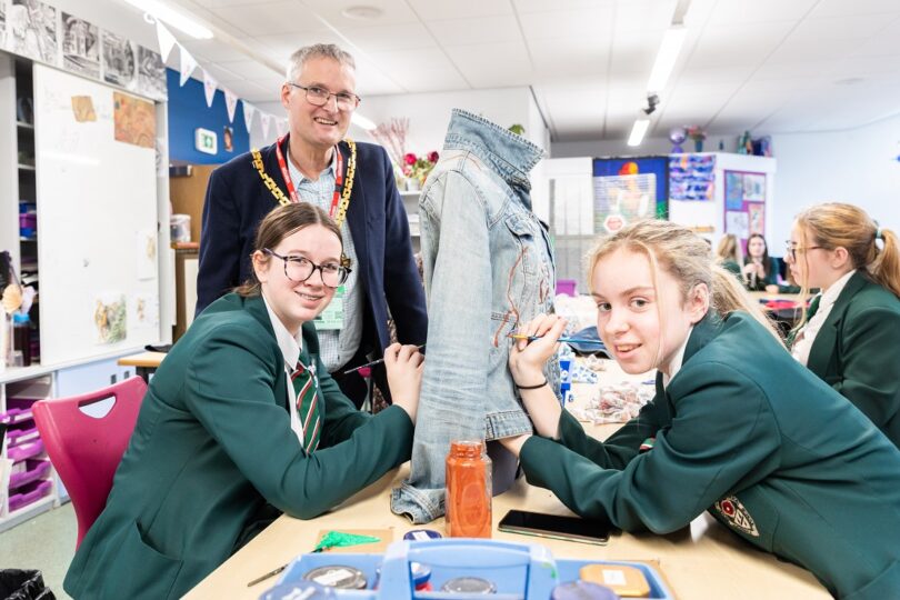 The Mayor with Nunnery Wood High School pupils  Natasha Lee and Lara Jackson, working on one of the outfits for his charity fashion show