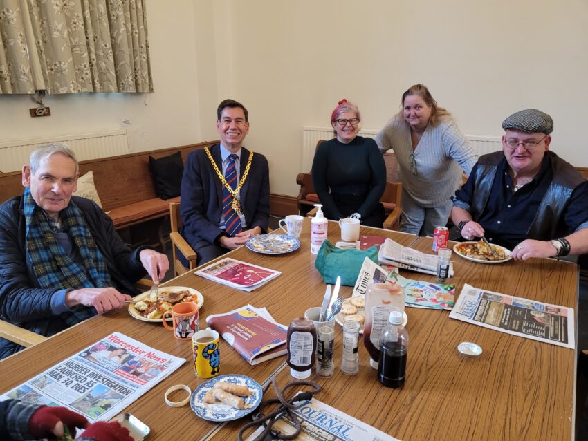 People say around a table eating