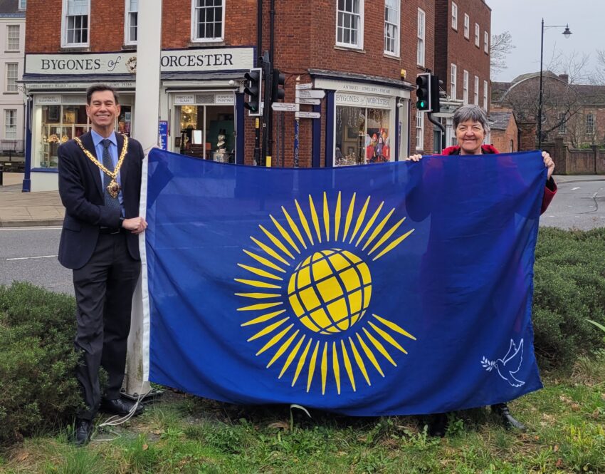 The Mayor and Councillor Lynn Denham raising the Commonwealth Flag