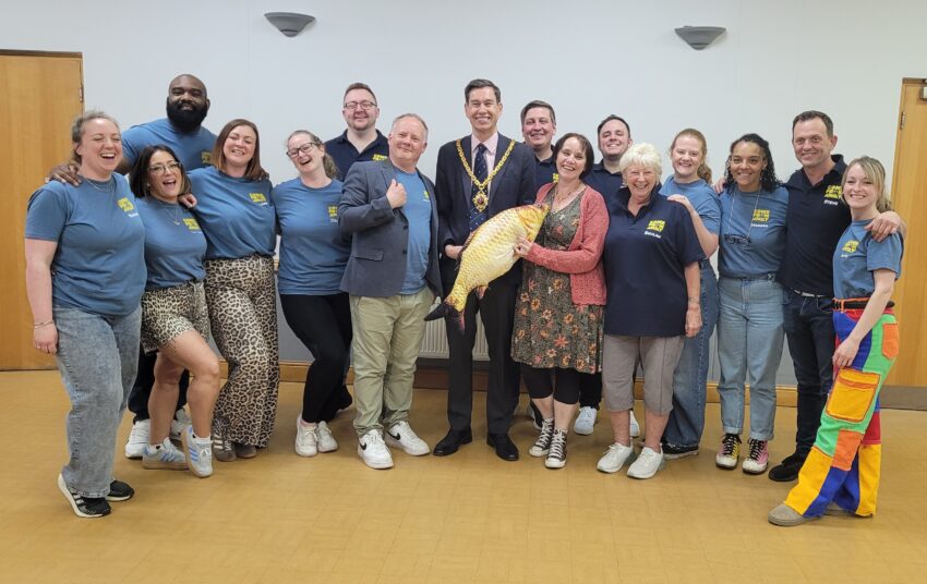The Mayor and Mayoress with a group of people, some in colourful outfits.