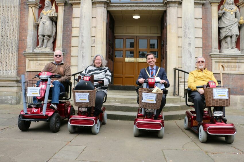 Matt Lamb with others on mobility scooters outside the Guildhall